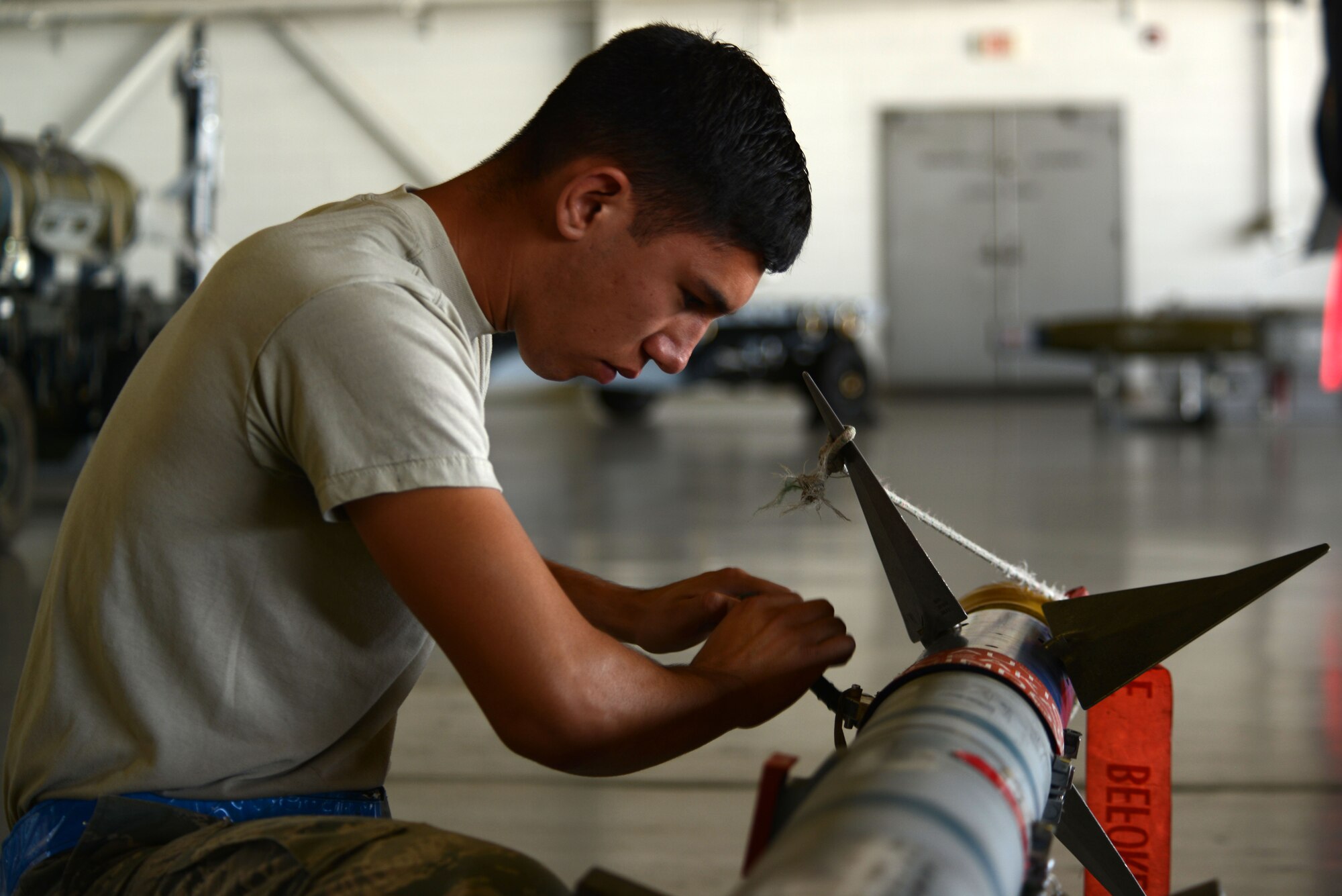 U.S. Air Force Airman 1st Class Rosendo Avalos, 20th Aircraft Maintenance Squadron, 55th Aircraft Maintenance Unit weapons load crew member, checks over each piece of a munition before it is loaded onto an F-16CM Fighting Falcon during a weapons load crew of the quarter competition at Shaw Air Force Base, S.C., Aug. 14, 2015. In addition to the load competition, Airmen were evaluated on their dress and appearance standards and were given a written test to assess their job knowledge. (U.S. Air Force photo by Airman 1st Class Kelsey Tucker/Released)