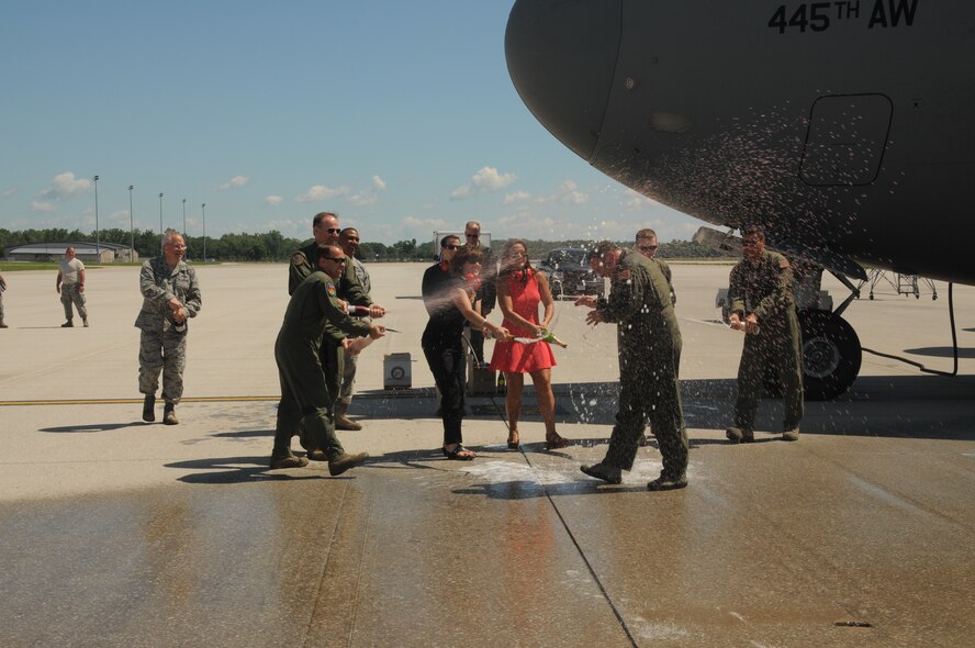 WRIGHT-PATTERSON AIR FORCE BASE, Ohio – Col.  Michael Major, 445th Airlift Wing vice commander, is sprayed with water and champagne by his family, friends and wing Airmen following his fini flight August 1, 2015. Major is retiring September 1 after more than 29 years of military service. He’s a C-17 command pilot with more than 6,300 hours. In his civilian capacity, he is a MD-11 First Officer with United Parcel Service. (U.S. Air Force photo/Tech. Sgt. Anthony Springer)