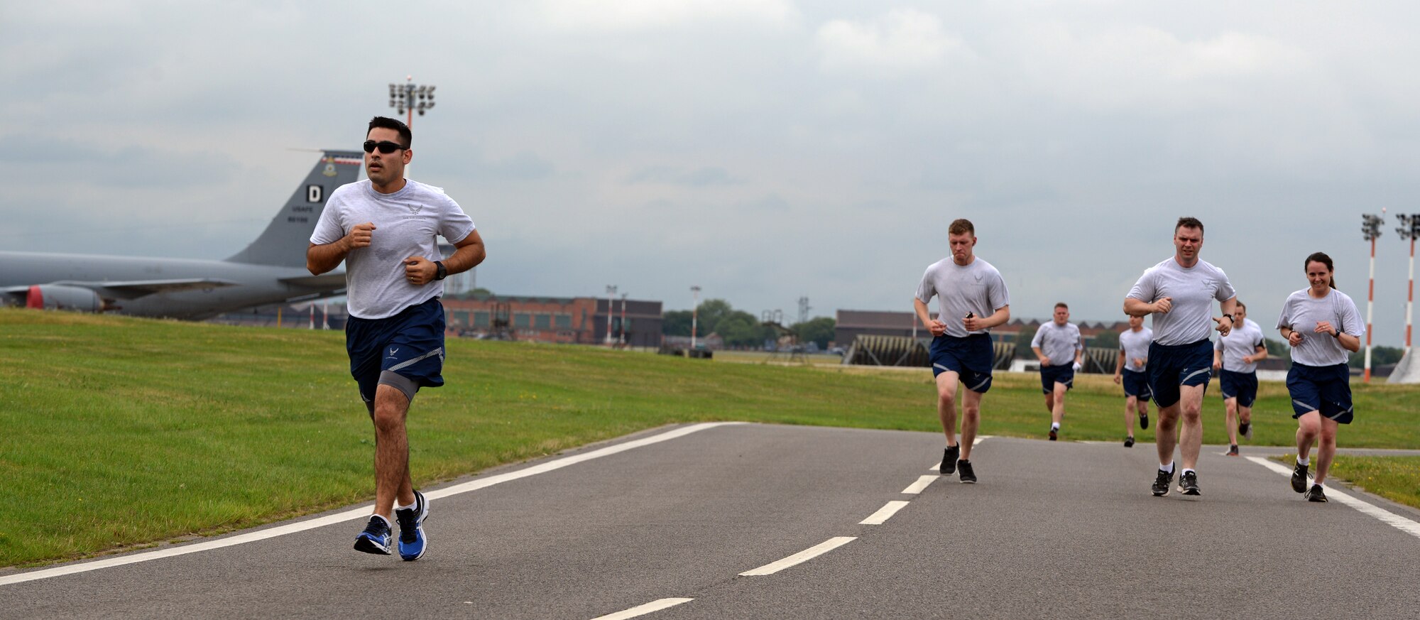Team Mildenhall Airmen finish their last half of the monthly 5k run Aug. 14, 2015, on RAF Mildenhall, England. Each month, participants begin the run at the Hardstand Fitness Center and run along the designated base perimeter route. (U.S. Air Force photo by Senior Airman Christine Halan/Released)