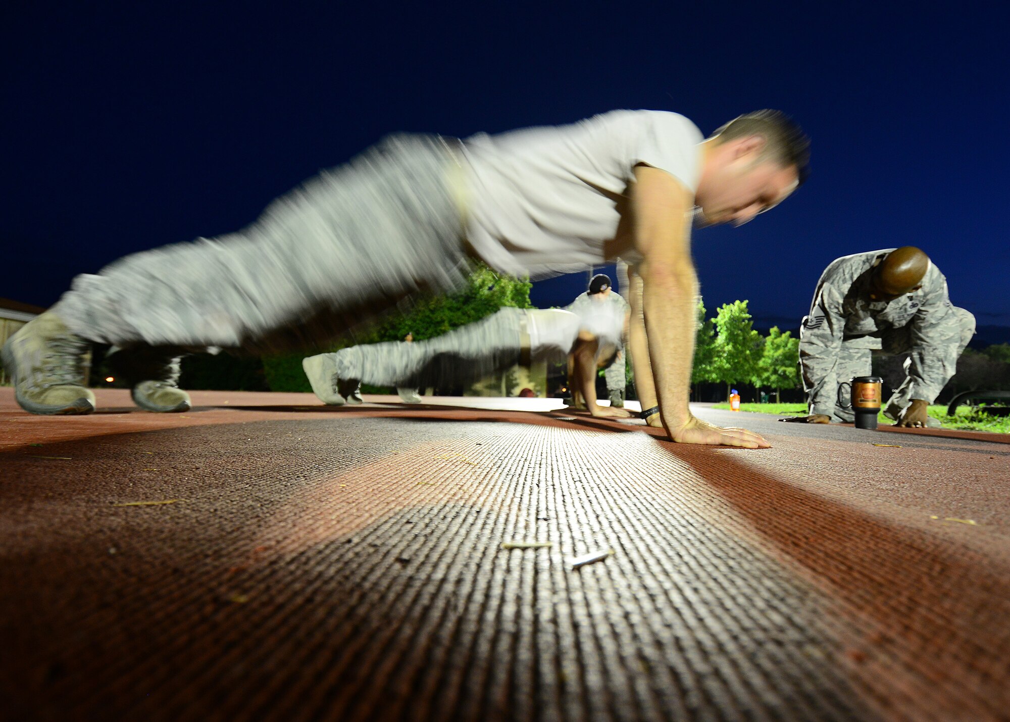 Airmen perform pushups during an Army pre-Ranger physical assessment, Aug. 5, 2015 at Aviano Air Base, Italy. The Aviano Airmen participated in the pre-Ranger course which included a 5-mile run, pushups, situps and chinups. (U.S. Air Force photo by Staff Sgt. Evelyn Chavez/Released)