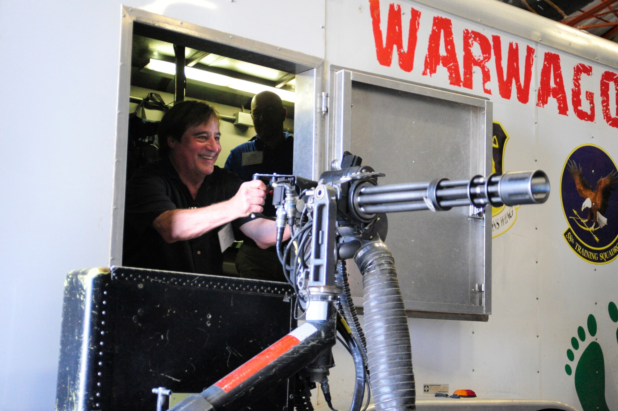 Jeff Lang, McChord Field civic leader, fires a mock 50-caliber machine gun during a tour of the 58th Special Operations Wing "Monster Garage," Aug. 13, 2015 as part of the 2015 McChord Field Fly-away Civic Leader tour of Kirtland Air Force Base, New Mexico. More than 20 civic leaders from the Puget Sound spent two days at Kirtland AFB learning what other Airmen in the Air Force do. (U.S. Air Force photo/Staff Sgt. Katie Jackson)