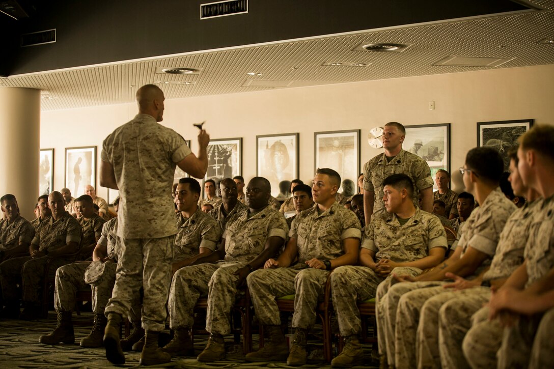 Maj. Gen. Richard L. Simcock II interacts with Sailors of the 3rd Marine Division during his speech over key issues in the pacific region at Camp Hansen, Okinawa, Japan, Aug. 7, 2015. Simcock, from San Mateo, California, expressed the importance of Sailors' role in maintaining Pacific stability by building stronger partnerships with allied nations in the region. Strong alliances among partnered nations increase reliability in peacekeeping and humanitarian operations, he explained. Simcock is the commanding general of 3rd Marine Division, III Marine Expeditionary Force. 