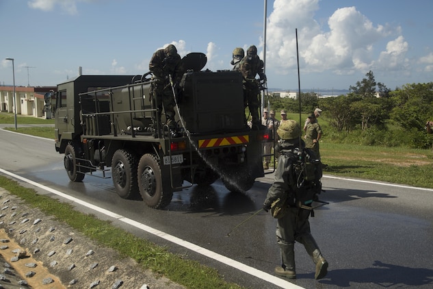 Marines and Japan Ground Self-Defense Force soldiers clean a mock contamination at Camp Hansen, Okinawa, July 30, 2015. The Chemical, Biological, Radiological, and Nuclear personnel participated in a combined integrated capabilities demonstration to identify how both units can benefit each other. The Marines are with CBRN Platoon, Headquarters Battalion, 3rd Marine Division, III Marine Expeditionary Force and Battery A, 1st Battalion, 12th Marine Regiment, under the Unit Deployment Program. The JGSDF soldiers are with Nuclear, Biological, Chemical Unit, 15th Brigade. 