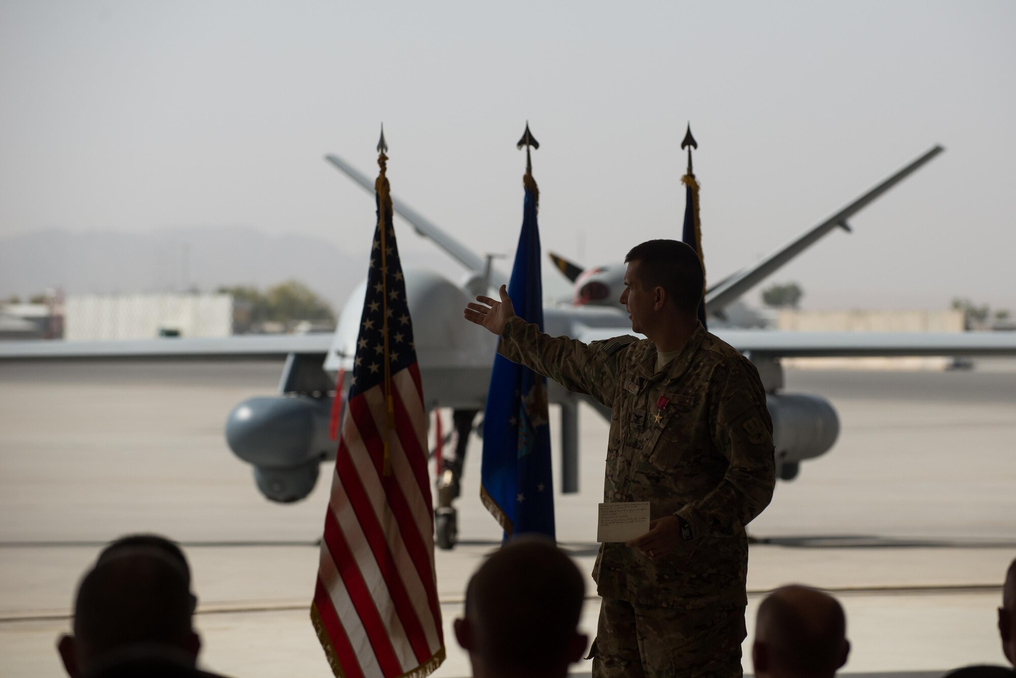 U.S. Air Force Col. Rhude Cherry III, 451st Air Expeditionary Group commander, speaks during the 451st AEG change of command ceremony at Kandahar Airfield, Afghanistan, Aug. 16, 2015. During the ceremony Cherry relinquished command of the 451st AEG to Col. James Curry.  (U.S. Air Force photo by Tech. Sgt. Joseph Swafford/Released)