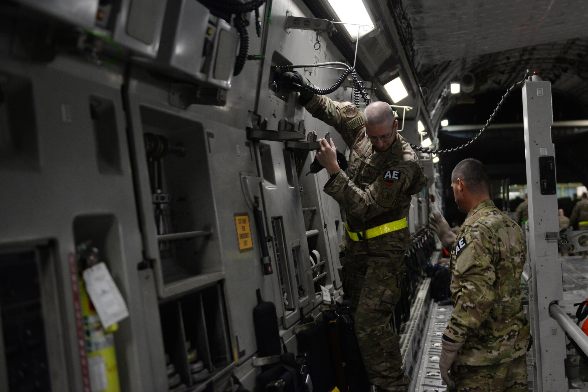 U.S. Air Force Capt. Christopher Novack, 455th Expeditionary Aeromedical Evacuation Squadron, and Tech. Sgt. Russell “Rusty” McLamb, left, 455th EAES AE technician deployed from the North Carolina Air National Guard’s 156th Aeromedical Evacuation Squadron, establish electrical and oxygen connections for medical equipment and supplies on a C-17 Globemaster III aircraft on the flight line at Bagram Airfield, Afghanistan, Aug. 9, 2015.  The 455th EAES Airmen are charged with the responsibility of evacuating the sick and wounded from Central Command to higher echelons of medical care. (U.S. Air Force photo by Maj. Tony Wickman/Released) 