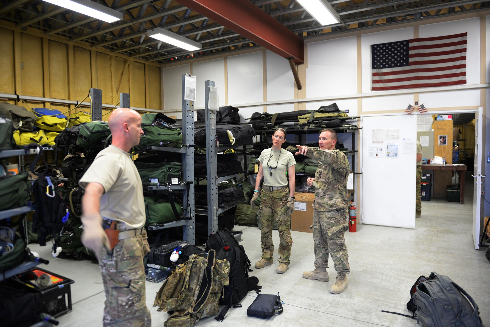 U.S. Air Force Senior Airman Margaret “Maggie” Mathewes, 455th Expeditionary Aeromedical Evacuation Squadron AE technician, and Lt. Col. David Bailey, right, 455th EAES chief nurse, and Chief Master Sgt. Bart Walters, 455th EAES superintendent, prepares equipment and supplies before an AE mission at Bagram Airfield, Afghanistan, Aug. 8, 2015.  The 455th EAES Airmen are charged with the responsibility of evacuating the sick and wounded from Central Command to higher echelons of medical care. (U.S. Air Force photo by Maj. Tony Wickman/Released)
