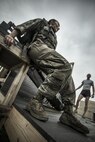 A female subject completes the final small unit tactics simulation, June 19, 2015, as a researcher from the Air Force Fitness Testing and Standards Unit ensure her safety. The Airman is a volunteer supporting the Physical Fitness Tests and Standards study at Joint Base San Antonio-Lackland, Texas. The study aims to establish occupationally-specific, operationally-relevant physical fitness standards for Battlefield Airmen. The small unit tactics simulation is one of 15 simulations designed to capture the most arduous physical demands of Battlefield Airmen. (U.S. Air Force Photo by 1st Lt. Jose R. Davis)
