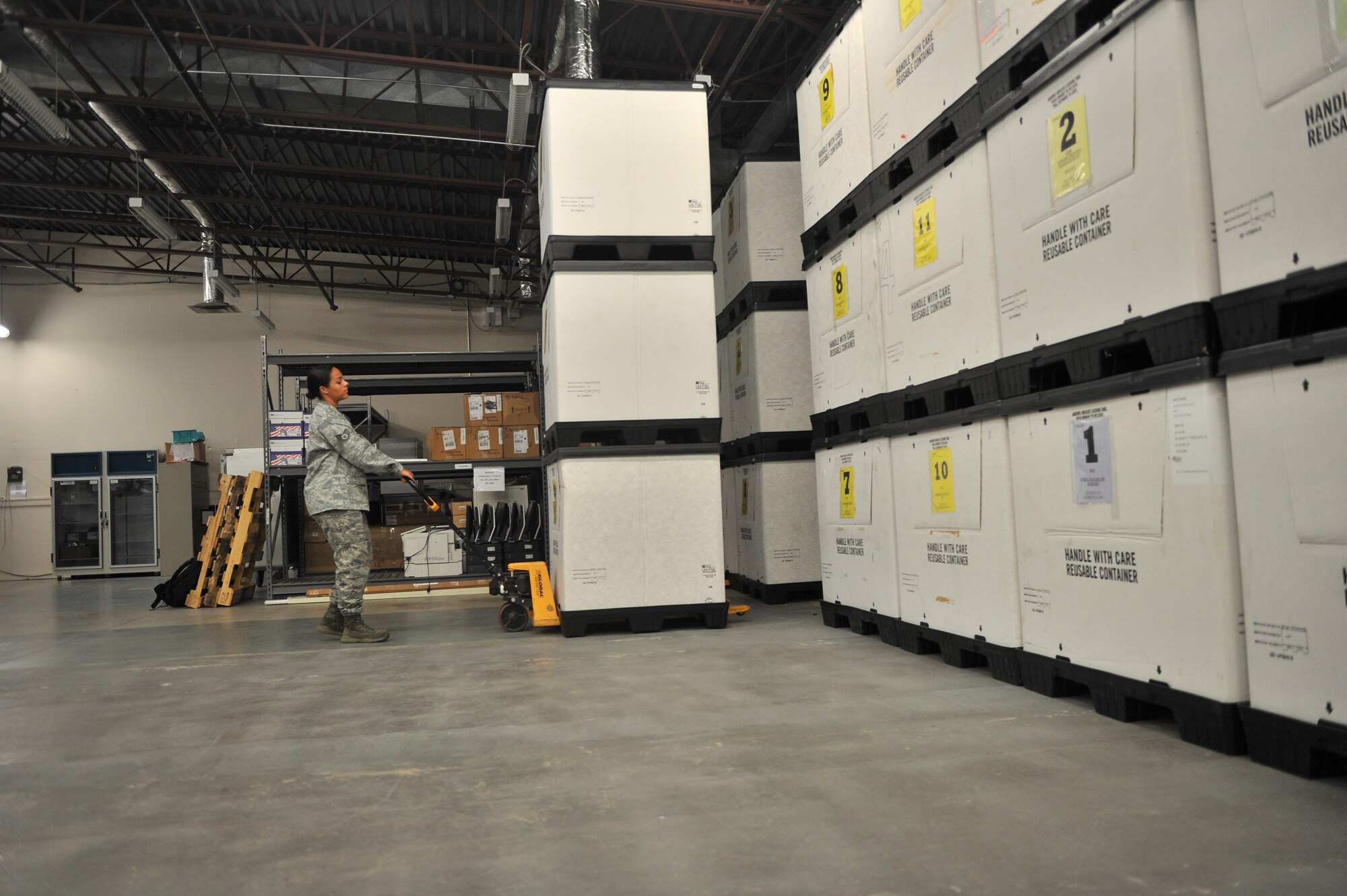 U.S. Air Force Staff Sgt. Martina Camacho, 97th Medical Group NCO in charge of the medical equipment management office, pushes a stack of equipment-storage bins back into place after conducting a routine inventory at Altus Air Force Base, Oklahoma, Aug. 13, 2015. The 97th MDG Logistics Flight stores emergency response supplies in the easy-to-access bins and routinely inventories them to ensure emergency response and mission readiness. (U.S. Air Force photo by Senior Airman Dillon Davis)