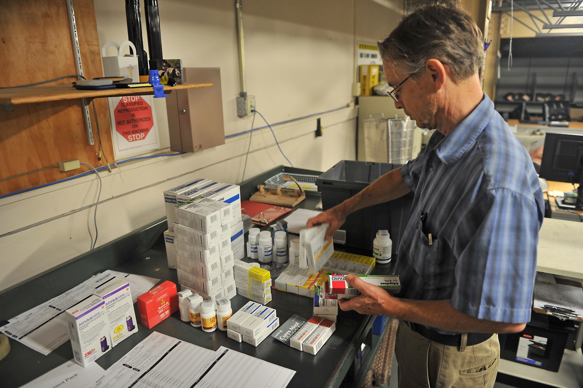 Steve Redeker, 97th Medical Group warehouse material manager, accounts for medical supplies inside the medical group warehouse at Altus Air Force Base, Oklahoma, Aug. 13, 2015. Redeker ensures the items are not about to expire and that they received their entire order. (U.S. Air Force photo by Senior Airman Dillon Davis)