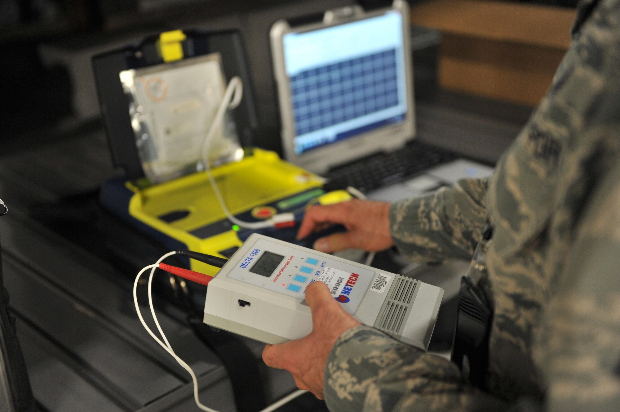 U.S. Air Force Tech. Sgt. Christian Bond, 97th Medical Group bioenvironmental medical equipment technician, tests an automated external defibrillator as part of routine maintenance on the devices inside medical group warehouse at Altus Air Force Base, Oklahoma, Aug. 13, 2015. Every AED device on base is supplied and maintained by the logistics flight to ensure safety for personnel. (U.S. Air Force photo by Senior Airman Dillon Davis)