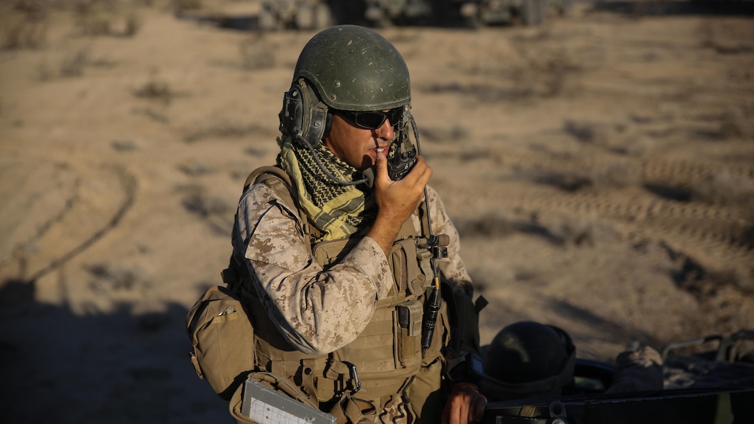 Capt. Francisco Vega, a company commander with 1st Battalion, 3rd Marine Regiment, communicates with Marines during a movement to contact exercise as part of Large Scale Exercise 15 at Marine Corps Air Ground Combat Center, Twentynine Palms, Calif., Aug. 14 – 15, 2015. LSE-15 is a combined U.S. Marine Corps, Canadian and British exercise conducted at the brigade level, designed to enable live, virtual and constructive training for participating forces. 