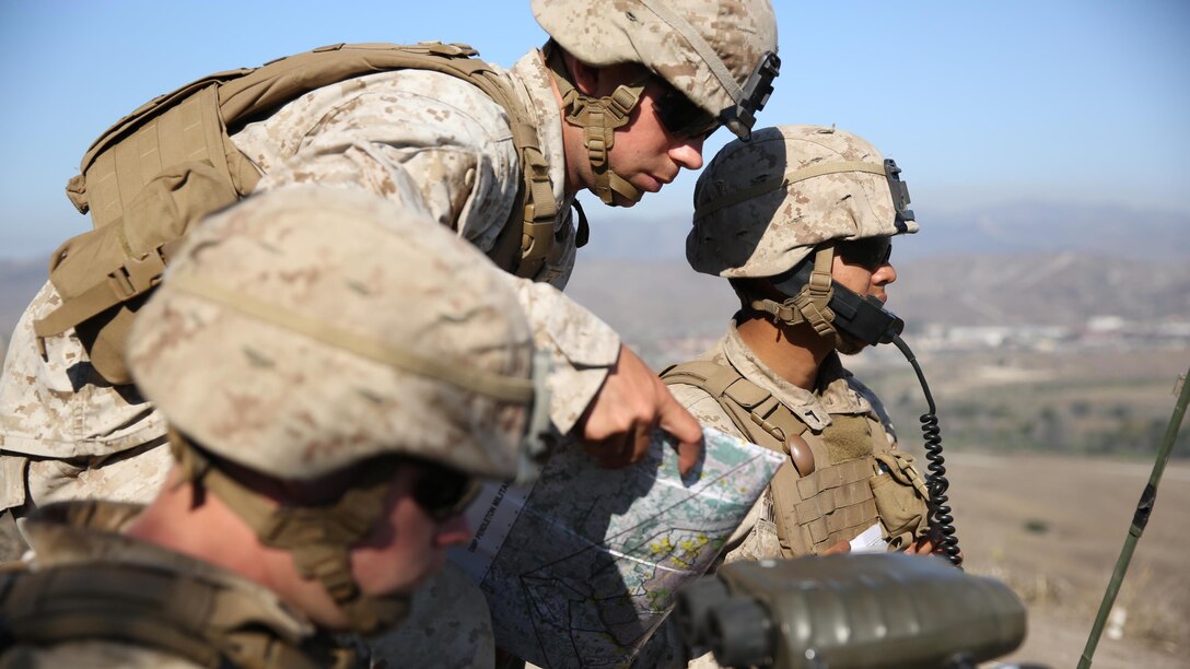 Corporal Brady Davenport (left), a fire support man, and 1st Lt. Mark Null (right), an artillery officer, both assigned to 2nd Battalion, 11th Marine Regiment, 1st Marine Division, observe impacts from M777 Howitzers at Marine Corps Base Camp Pendleton, Calif., Aug. 14, 2015. 2/11 annually conducts Summer Fire Exercise to sustain core proficiencies and to further develop their ability to execute fire missions.