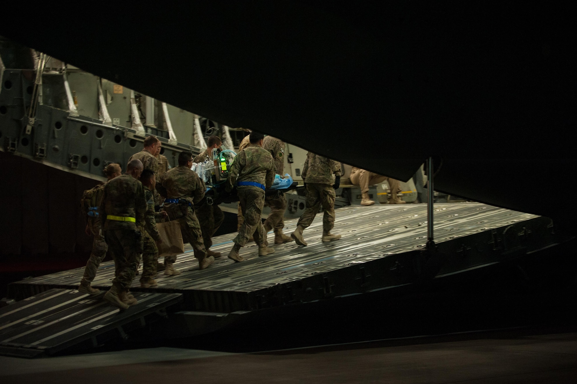U.S. Airmen assigned to the 455th Expeditionary Aeromedical Evacuation Squadron and the 455th Expeditionary Medical Group load injured Service members onto a C-17 Globemaster III aircraft on the flight line at Bagram Airfield, Afghanistan, Aug. 8, 2015.  The 455th EAES Airmen are charged with the responsibility of evacuating the sick and wounded from Central Command to higher echelons of medical care. (U.S. Air Force photo by Tech. Sgt. Joseph Swafford/Released) 