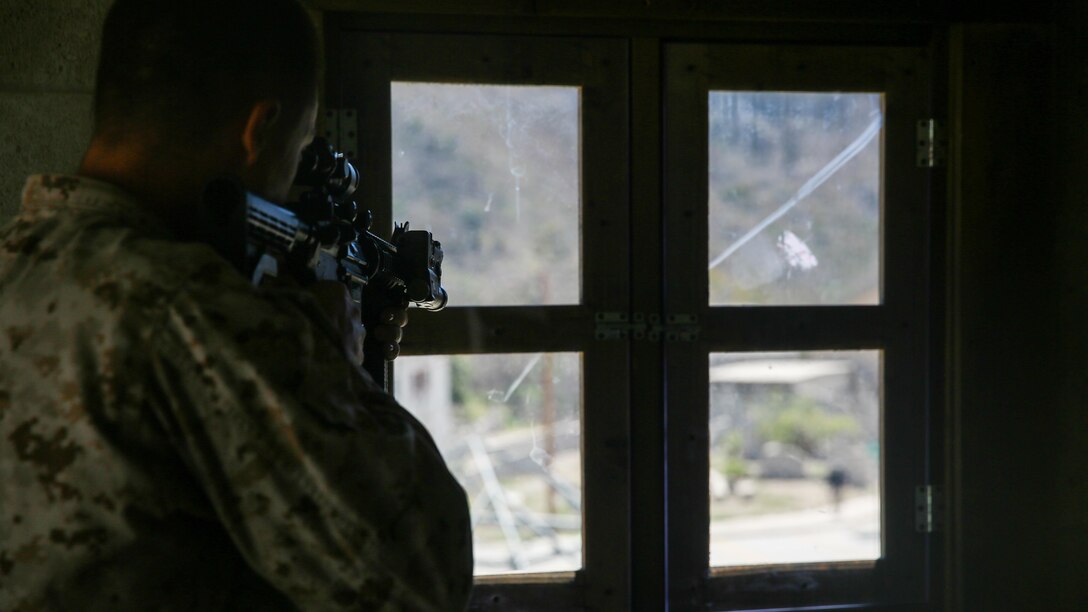 A Marine with 2nd Battalion, 7th Marine Regiment sights in on a simulated enemy during the culminating event of 1st Marine Division Schools’ Urban Leaders Course at Marine Corps Base Camp Pendleton, Calif., Aug. 12, 2015. The course is a 15-day period of instruction that includes classwork, combat marksmanship and physical training executed in a simulated urban combat environment. 