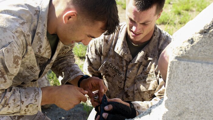 Marines with 1st Battalion, 7th Marine Regiment, and 2nd Battalion, 7th Marine Regiment, set a simulated booby trap to alert nearby Marines when an enemy is attempting to infiltrate their position during the culminating event of 1st Marine Division Schools’ Urban Leaders Course at Marine Corps Base Camp Pendleton, Calif., Aug. 12, 2015. The course is a 15-day period of instruction that includes classwork, combat marksmanship and physical training executed in a simulated urban combat environment. 