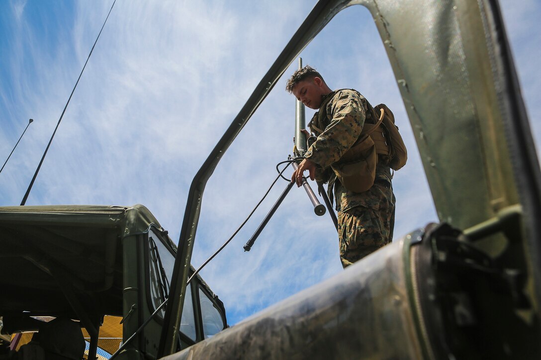 Marines with Company B, 1st Battalion, 1st Marine Regiment set up communication assets after conducting Military Operations in Urban Terrain in a simulated combat town by using M1161 Internally Transportable Vehicles during the first phase of a Limited Objective Experiment aboard Marine Corps Base Camp Pendleton, Calif., Aug. 13, 2015. The experiment is comprised of  the integration of ITVs with infantry units to provide the Marine Corps Warfighting Laboratory with an understanding of how the vehicles will be added to the battalions. The second part of the experiment will take place at Fort Hunter Liggett, Calif., which will provide the Marines with extensive amounts of terrain to test the vehicles’ capabilities over a 3-week training period. (U.S. Marine Corps Photo by Sgt. Rick Hurtado / Released)