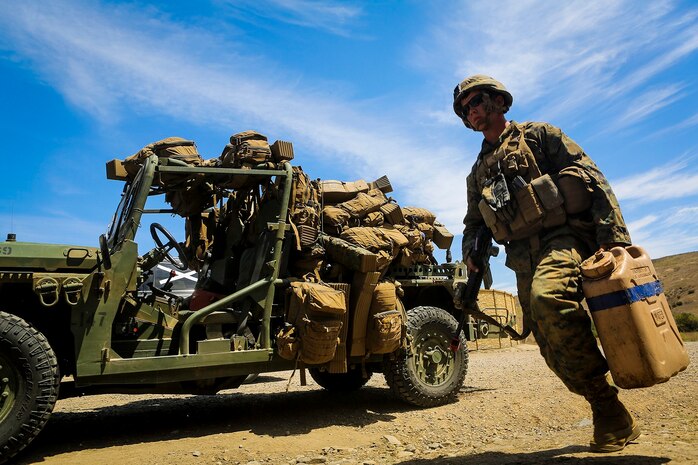 Private First Class Jonathan Meissen, a native of Parsons, Kan., and a basic rifleman with Company B, 1st Battalion, 1st Marine Regiment, unloads jugs of water off an M1161 Internally Transportable Vehicle during the first phase of a Limited Objective Experiment aboard Marine Corps Base Camp Pendleton, Calif., Aug. 13, 2015. The experiment is comprised of the integration of ITVs with infantry units to provide the Marine Corps Warfighting Laboratory with an understanding of how the vehicles will be added to the battalions. The second part of the experiment will take place at Fort Hunter Liggett, Calif., which will provide the Marines with extensive amounts of terrain to test the vehicles’ capabilities over a 3-week training period. (U.S. Marine Corps Photo by Sgt. Rick Hurtado / Released)