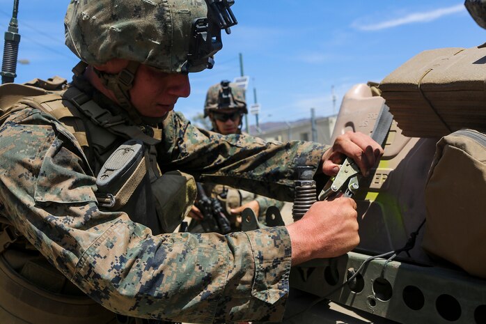 Lance Cpl. Erik Kostura, a native of Cleveland, and a radio operator with Company B, 1st Battalion, 1st Marine Regiment, prepares to unload jugs of water off an M1161 Internally Transportable Vehicle during the first phase of a Limited Objective Experiment aboard Marine Corps Base Camp Pendleton, Calif., Aug. 13, 2015. The experiment is comprised of the integration of ITVs with infantry units to provide the Marine Corps Warfighting Laboratory with an understanding of how the vehicles will be added to the battalions. The second part of the experiment will take place at Fort Hunter Liggett, Calif., which will provide the Marines with extensive amounts of terrain to test the vehicles’ capabilities over a 3-week training period. (U.S. Marine Corps Photo by Sgt. Rick Hurtado / Released)