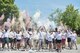 910th Airlift Wing members throw colored powder into the air to start a color run here, August 2. The color run was a 5k race as part of Family Day activities. Family Day is an annual event allowing Wing members to bring their family to the base for a day of fun and educational activities with their unit. (U.S. Air Force photo/Staff Sgt. Rachel Kocin)