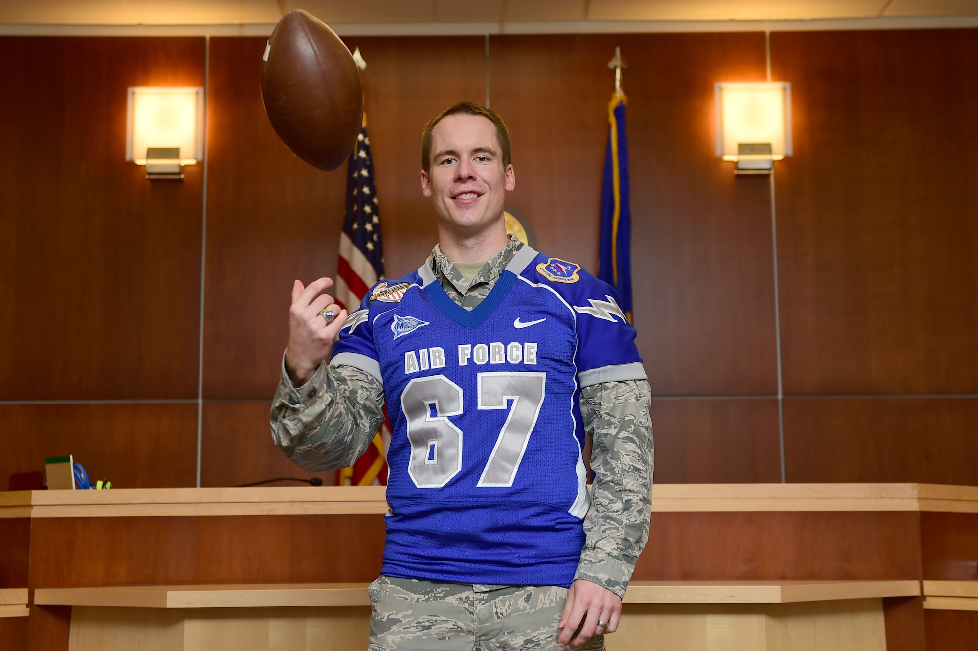 Capt. Tyler Weeks, a 460th Space Wing Staff Judge Advocate intern, wears his U.S. Air Force Academy Falcons jersey Aug. 12, 2015, on Buckley Air Force Base, Colo. Weeks played offensive line for the Falcons during his four years at the Academy. He is pursuing a law degree from the University of Colorado Law School and interned at the legal office during the summer. (U.S. Air Force photo/Airman 1st Class Luke W. Nowakowski)
