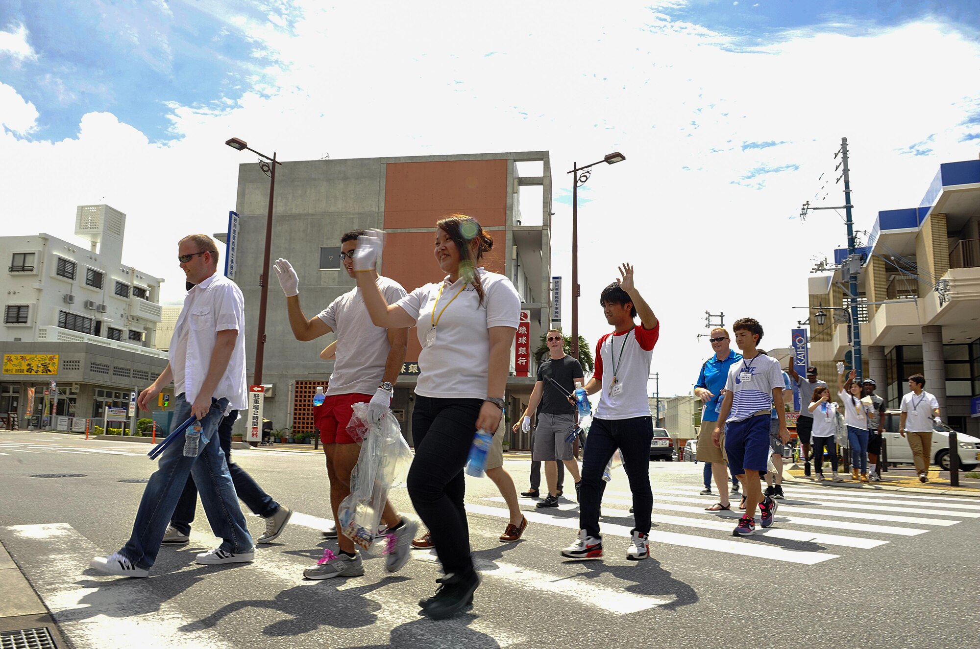 Kadena Language Institute students clean up Kadena Town Main Street alongside volunteers from 18th Wing at Kadena Town, Japan, Aug. 14, 2015. KLI is a two-year vocational school where students ages 19-24 learn different languages including English and study Okinawan culture. (U.S. Air Force photo by Naoto Anazawa/Released)