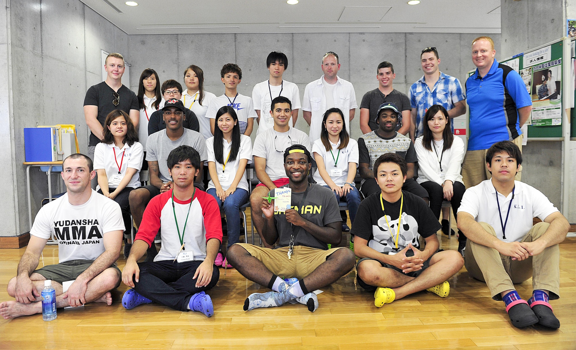 Kadena Language Institute students pose with volunteers from the 18th Wing for a group photo after a culture exchange at Kadena Rotary Plaza, Japan, Aug. 14, 2015. Ten volunteers participated with the institute to clean the neighborhood as part of a community relations event while also conversing with KLI students in English. (U.S. Air Force photo by Naoto Anazawa/Released)