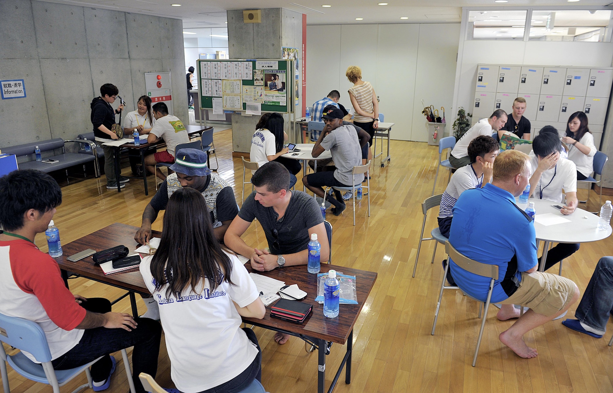 Kadena Language Institute students present Japanese culture and traditional games to U.S. Air Force volunteers from the 18th Wing during a culture exchange program at Kadena Rotary Plaza, Japan, Aug. 14, 2015. The culture exchange program was divided six sections; which included sanshin (Okinawa traditional guitar), origami and kanji. (U.S. Air Force photo by Naoto Anazawa/Released)