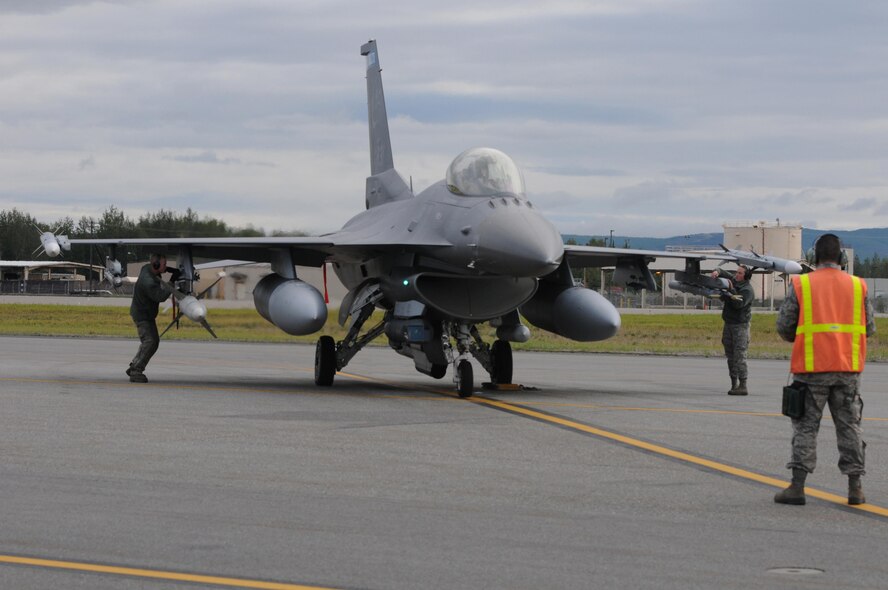 U.S. Air Force weapons load Airmen from the 148th Fighter Wing, Duluth, Minnesota, perform a pre-flight inspection while at Eielson Air Force Base, Alaska, Aug. 11, 2015, during RED FLAG-Alaska 15-3.  RF-A is a Pacific Air Forces commander-directed field training exercise for U.S. and partner nation forces, providing combined offensive counter-air, interdiction, close air support and large force employment training in a simulated combat environment.  (U.S. Air Force photo by Master Sgt. Ralph Kapustka/Released)