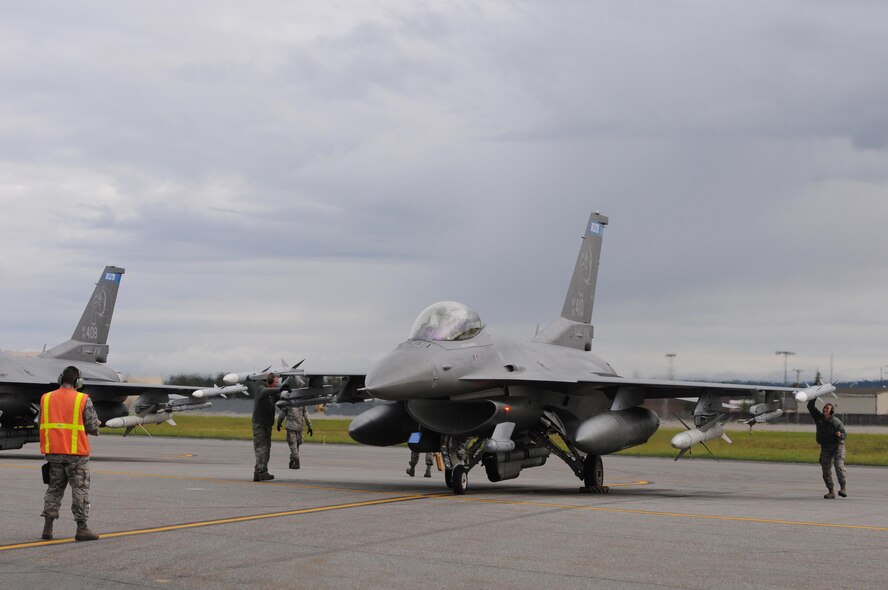 U.S. Air Force weapons load Airmen from the 148th Fighter Wing, Duluth, Minnesota, perform final inspections before take-off on a F-16 Fighting Falcon at Eielson Air Force Base, Alaska, Aug. 11, 2015, during RED FLAG-Alaska 15-3.  RF-A is a Pacific Air Forces commander-directed field training exercise for U.S. and partner nation forces, providing combined offensive counter-air, interdiction, close air support and large force employment training in a simulated combat environment.  (U.S. Air Force photo by Master Sgt. Ralph Kapustka/Released)