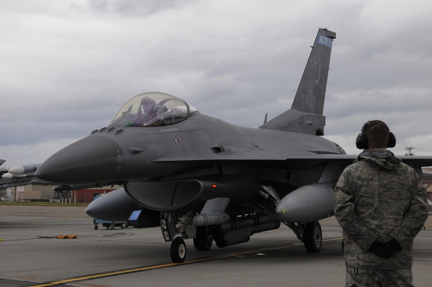A U.S. Air Force crew chief with the 148th Fighter Wing, Duluth, Minnesota, goes through pre-flight checks with an F-16 pilot Aug. 10, 2015, while participating in RED FLAG-Alaska 15-3 at Eielson Air Force Base, Alaska. RF-A is a Pacific Air Forces commander-directed field training exercise for U.S. and partner nation forces, providing combined offensive counter-air, interdiction, close air support and large force employment training in a simulated combat environment.  (U.S. Air Force photo by Master Sgt. Ralph Kapustka/Released)