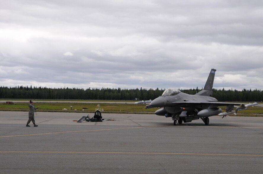 U.S. Air Force Staff Sgt. Chelsea Lien, a 148th Fighter Wing crew chief, Duluth, Minnesota, goes through pre-flight checks with an F-16 pilot, Aug. 10, 2015, while participating in RED FLAG-Alaska 15-3 at Eielson Air Force Base, Alaska. RF-A is a Pacific Air Forces commander-directed field training exercise for U.S. and partner nation forces, providing combined offensive counter-air, interdiction, close air support and large force employment training in a simulated combat environment.  (U.S. Air Force photo by Master Sgt. Ralph Kapustka/Released)