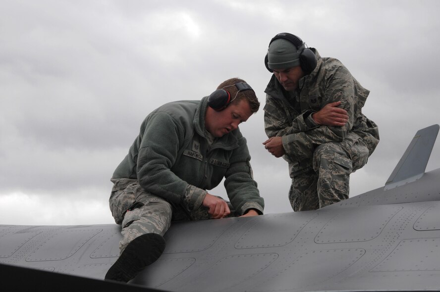 U.S. Air Force Tech. Sgt. Sterling Hartwick and Staff Sgt. Chad Rochwite, both from the148th Fighter Wing, Duluth, Minnesota, perform repairs to the air refueling door on an F-16, Aug. 10, 2015, while participating in RED FLAG-Alaska 15-3 at Eielson Air Force Base, Alaska. RF-A is a Pacific Air Forces commander-directed field training exercise for U.S. and partner nation forces, providing combined offensive counter-air, interdiction, close air support and large force employment training in a simulated combat environment.  (U.S. Air Force photo by Master Sgt. Ralph Kapustka/Released)