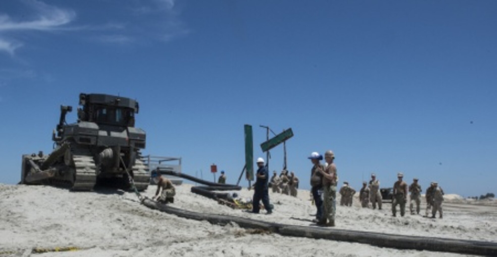 Marines with Bulk Fuel Co., 1st Marine Logistics Group, team up with Sailors from Amphibious Construction Battalion 1 to perform a beach unloading exercise using the Beach Termination Unit, in Coronado, Calif., Aug. 1-4, 2015. Approximately 30 Marines with Bulk Fuel Company, 7th Engineer Support Battalion, 1st Marine Logistics Group, teamed up with Sailors from Amphibious Construction Battalion 1 to conduct a beach unloading exercise. What made the training unique was the use of the BTU, which allows Marines to transfer fuel from a ship out in the ocean to Marines on land.
