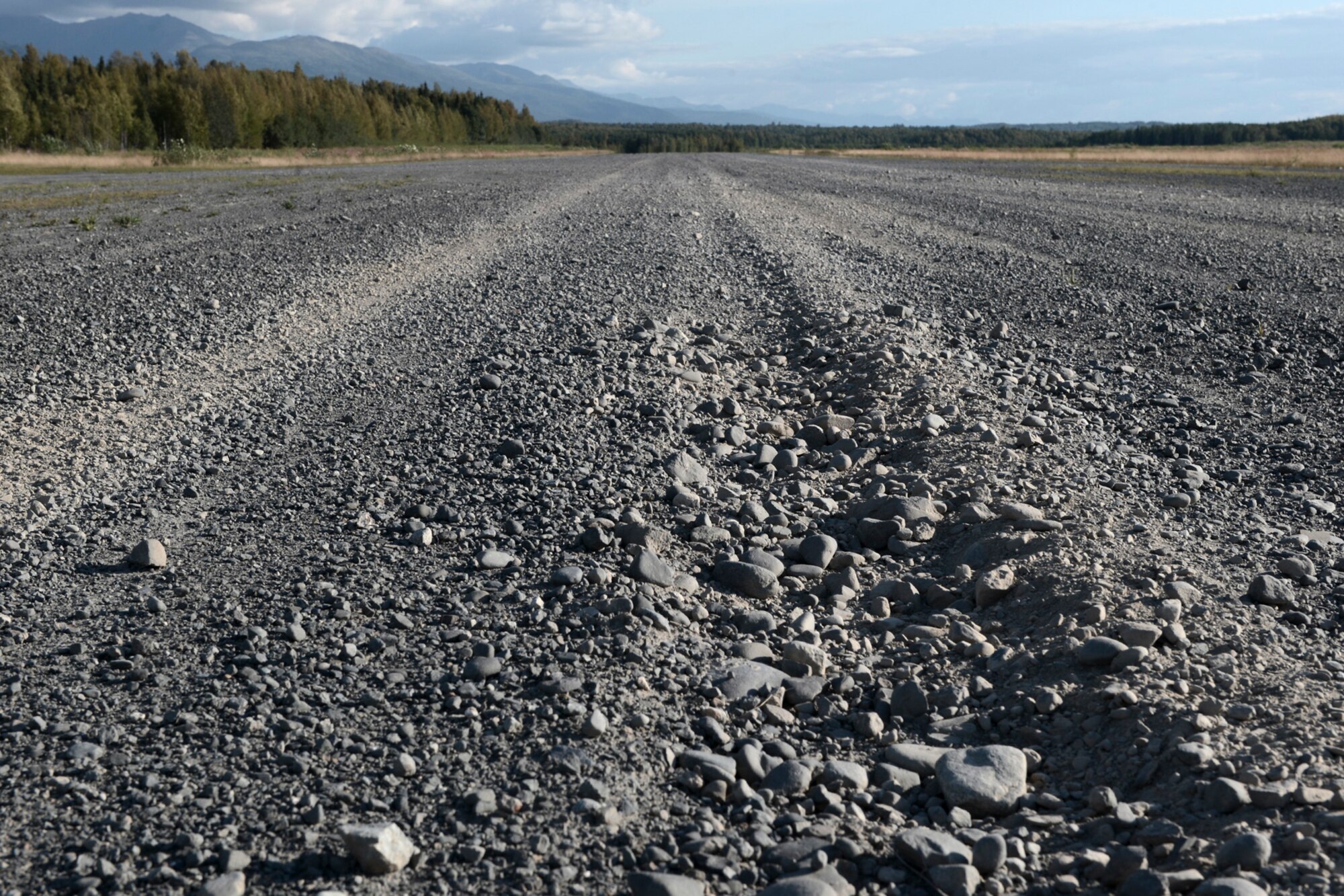 Tire marks left by a C-130 Hercules landing are seen on an austere runway used for training during RED FLAG-Alaska at Joint Base Elmendorf-Richardson, Alaska, Aug. 14, 2015. The training allowed C-130 aircrew to practice austere landings and take offs, combat offloads and supply drops, but also allowed friendly competition between participating Air Forces: U.S. Air Force, Japan Air Self-Defense Force, Royal Air Force, Royal Australian Air Force, Royal New Zealand Air Force and Royal Thai Air Force. Seasoned C-130 aircrew from each country judged the training exercises from the ground, allotting points based off predetermined timing and accuracy requirements. (U.S. Air Force photo by Staff Sgt. Cody H. Ramirez/Released)