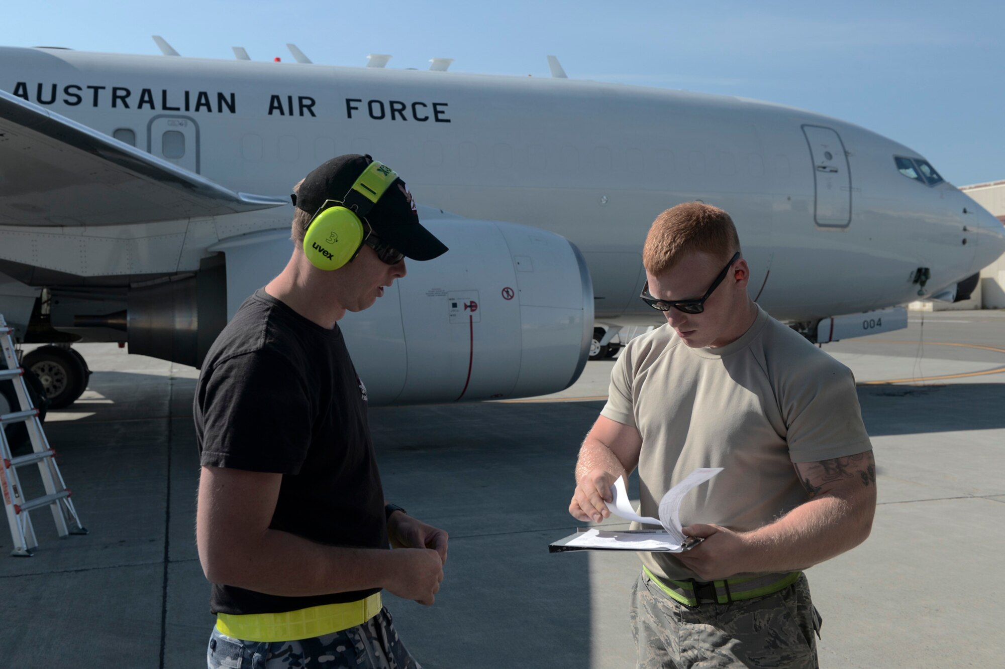 (Right) U.S. Air Force Senior Airman Reinhardt Andersen completes a fuels work order with Kayne Markham, Royal Australian Air Force leading aircraftsman with the 42 Wing, 2 Squadron, during RED FLAG-Alaska at Joint Base Elmendorf-Richardson, Alaska, Aug. 14, 2015. Andersen is with the 18th Logistical Readiness Squadron out of Kadena Air Base, Japan. (U.S. Air Force photo by Staff Sgt. Cody H. Ramirez/Released)
