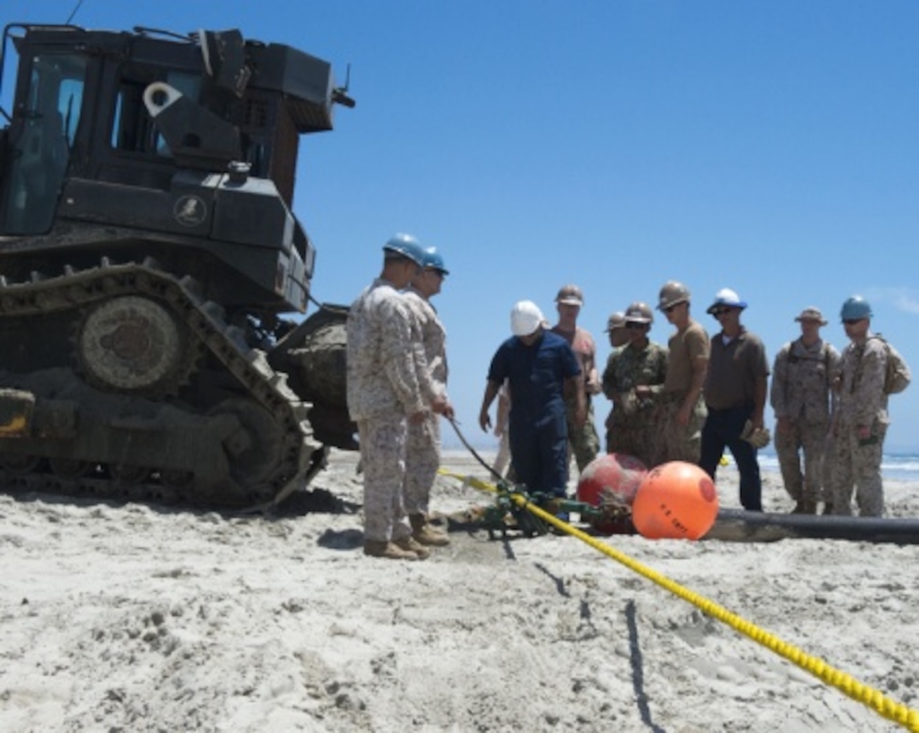 Marines with Bulk Fuel Co., 1st Marine Logistics Group, team up with Sailors from Amphibious Construction Battalion 1 to perform a beach unloading exercise using the Beach Termination Unit, in Coronado, Calif., Aug. 1-4, 2015. Approximately 30 Marines with Bulk Fuel Company, 7th Engineer Support Battalion, 1st Marine Logistics Group, teamed up with Sailors from Amphibious Construction Battalion 1 to conduct a beach unloading exercise. What made the training unique was the use of the BTU, which allows Marines to transfer fuel from a ship out in the ocean to Marines on land.