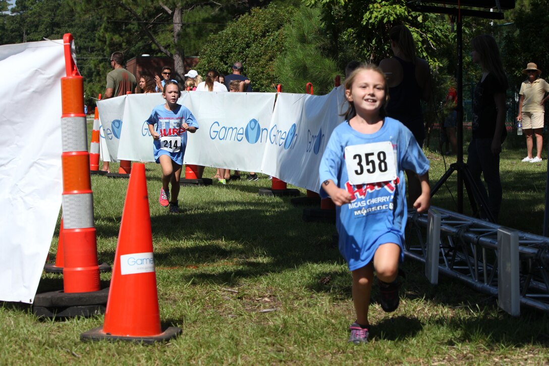 Youth participants race to the finish line during the Marine Corps Community Services’ annual Sprint Triathlon Relay and Kids Triathlon at Marine Corps Air Station Cherry Point, North Carolina, Aug. 15, 2015. Service members and families in the local community had friendly competition in the multisport event. After the adults’ endurance swim, bike and run, the younger athletes followed suit in a less daunting 150-meter swim, eight-mile bike ride and three-mile run. Children below the age of 9 swam 100 meters, rode bike for three miles and ran for 1 ½ miles.