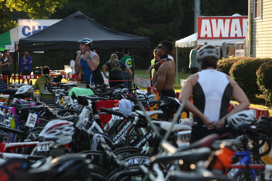Adults change for the bicycle leg of the Marine Corps Community Services’ annual Sprint Triathlon Relay and Kids Triathlon at Marine Corps Air Station Cherry Point, North Carolina, Aug. 15, 2015. Service members and families in the local community had friendly competition in the multisport event. After the adults’ endurance swim, bike and run, the younger athletes followed suit in a less daunting 150-meter swim, eight-mile bike ride and three-mile run. Children below the age of 9 swam 100 meters, rode bike for three miles and ran for 1 ½ miles.