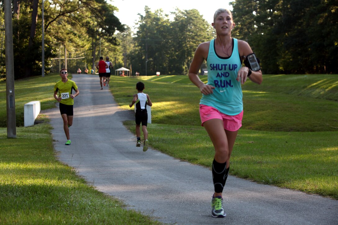 Racers run during final portion of the Marine Corps Community Services’ annual Sprint Triathlon Relay and Kids Triathlon at Marine Corps Air Station Cherry Point, North Carolina, Aug. 15, 2015. Service members and families in the local community had friendly competition in the multisport event. After the adults’ endurance swim, bike and run, the younger athletes followed suit in a less daunting 150-meter swim, eight-mile bike ride and three-mile run. Children below the age of 9 swam 100 meters, rode bike for three miles and ran for 1 ½ miles.