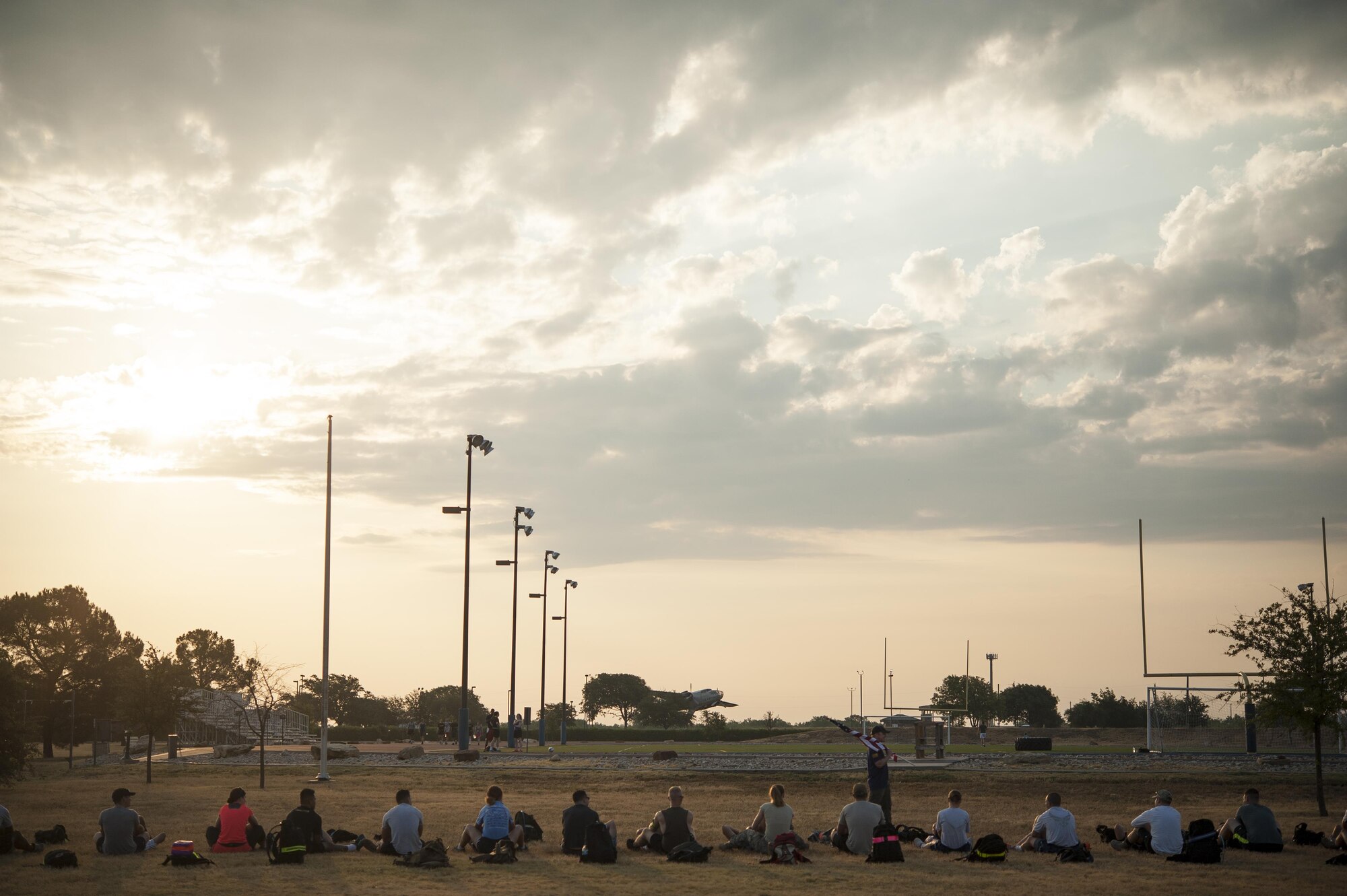 Team Cohesion Challenge participants do full body sit-up at the Mathis Fitness Center on Goodfellow Air Force Base, Texas, Aug. 15, 2015. The five hour event began with various full body workouts and ended with a 6 mile ruck march. (U.S. Air Force photo by Staff Sgt. Michael Smith/Released)