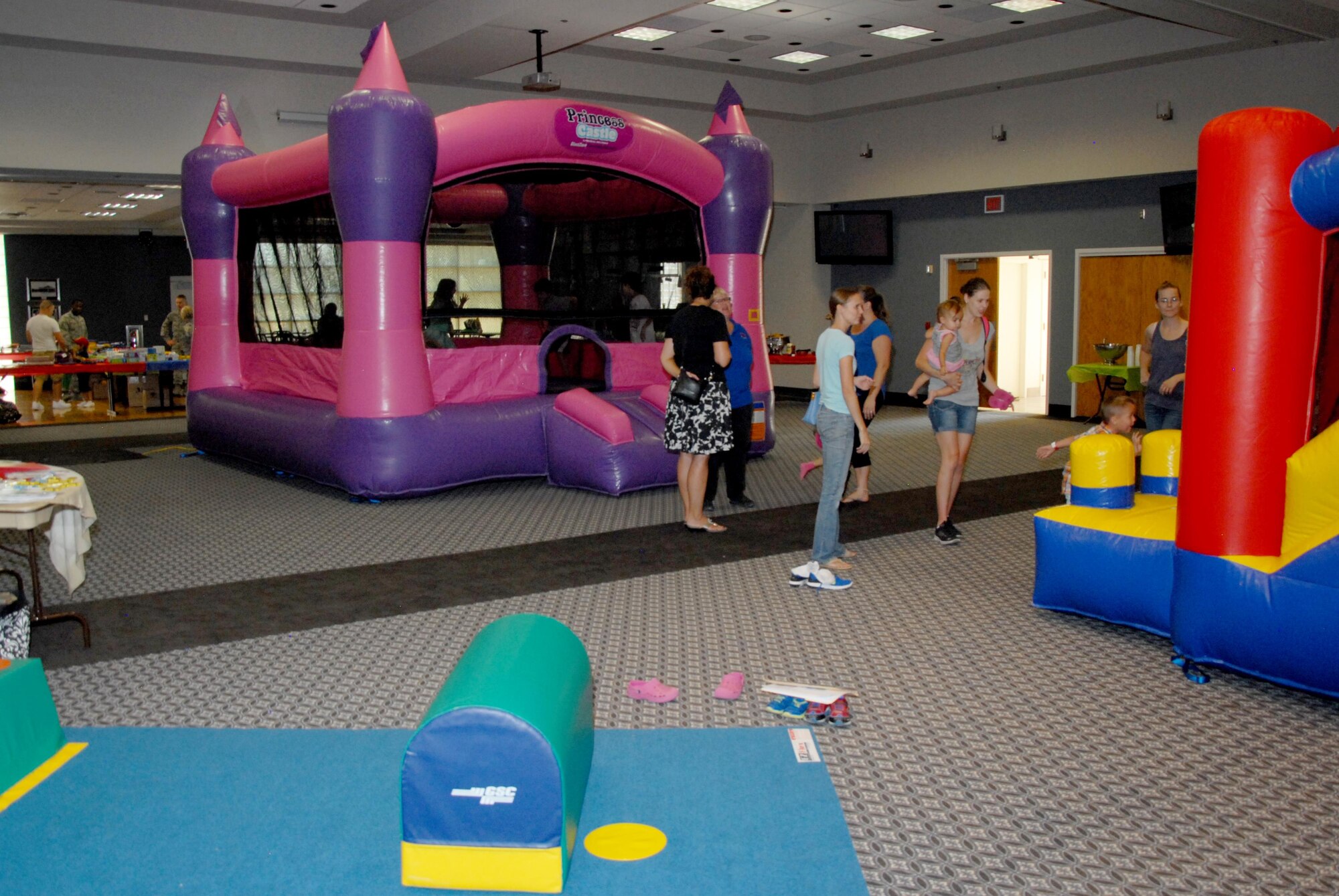Parents watch their children play during the Bounce Back to School Family Night at the Event Center on Goodfellow Air Force Base, Texas, Aug. 17, 2015. Volunteers donated school supplies and also assisted with the event, helping parents and children get a head start to the school year. (U.S. Air Force photo by Senior Airman Joshua Edwards/Released)