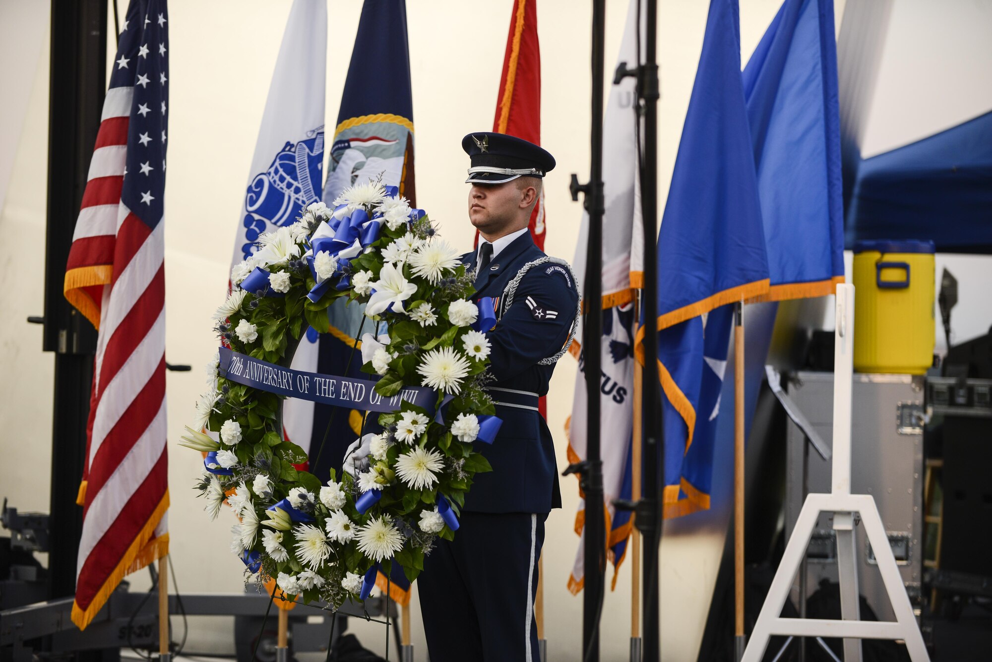 An Airman with the Air Force Honor Guard presents the wreath used in the wreath-laying ceremony at the Air Force Memorial in Arlington, Virginia, commemorating the 70th anniversary of the end of World War II, Aug. 14, 2015. The Air Force Band also put on a concert playing music from the World War II era.  (Air Force photo/Tech. Sgt. Joshua L. DeMotts)
