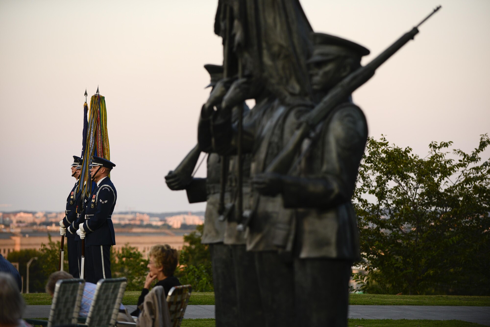Members of the Air Force Honor Guard standby to present the colors during a wreath-laying ceremony, a four-ship P-51 Mustang flyover and the Air Force Band concert commemorating the 70th anniversary of the end of World War II, Aug. 14, 2015 at the Air Force Memorial in Arlington, Virginia. (Air Force photo/Tech. Sgt. Joshua L. DeMotts)
