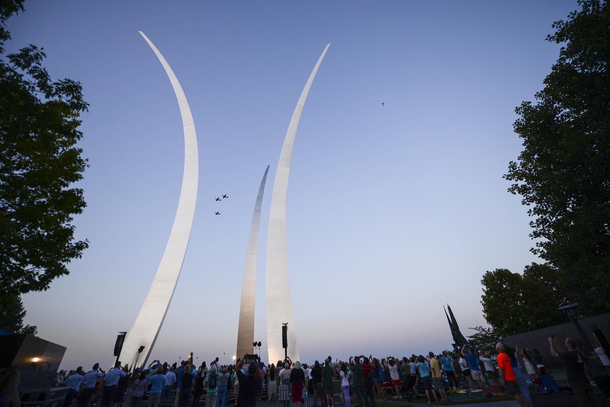 A formation of P-51 Mustangs perform a flyover at the Air Force Memorial in Arlington, Virginia, commemorating the 70th anniversary of the end of World War II, Aug. 14, 2015. The Air Force Band also put on a concert playing music from the World War II era. (Air Force photo/Tech. Sgt. Joshua L. DeMotts)