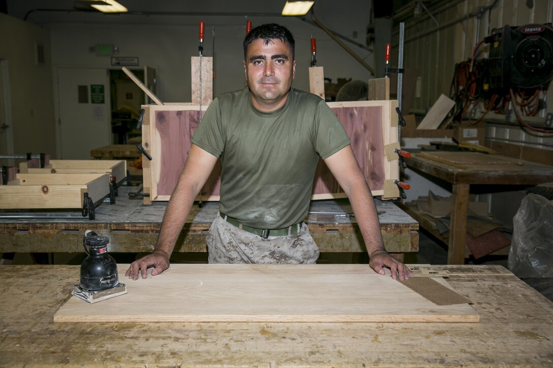 Staff Sgt. Pablo Alarcon, warehouse chief, 1st Tank Battalion, enjoys spending time at the Combat Center’s Wood Hobby Shop working on projects to give as going away and retirement gifts. Since he started woodworking a year ago he has made approximately 15 unique designs. (Official Marine Corps photo by Pfc. Levi Schultz/Released)