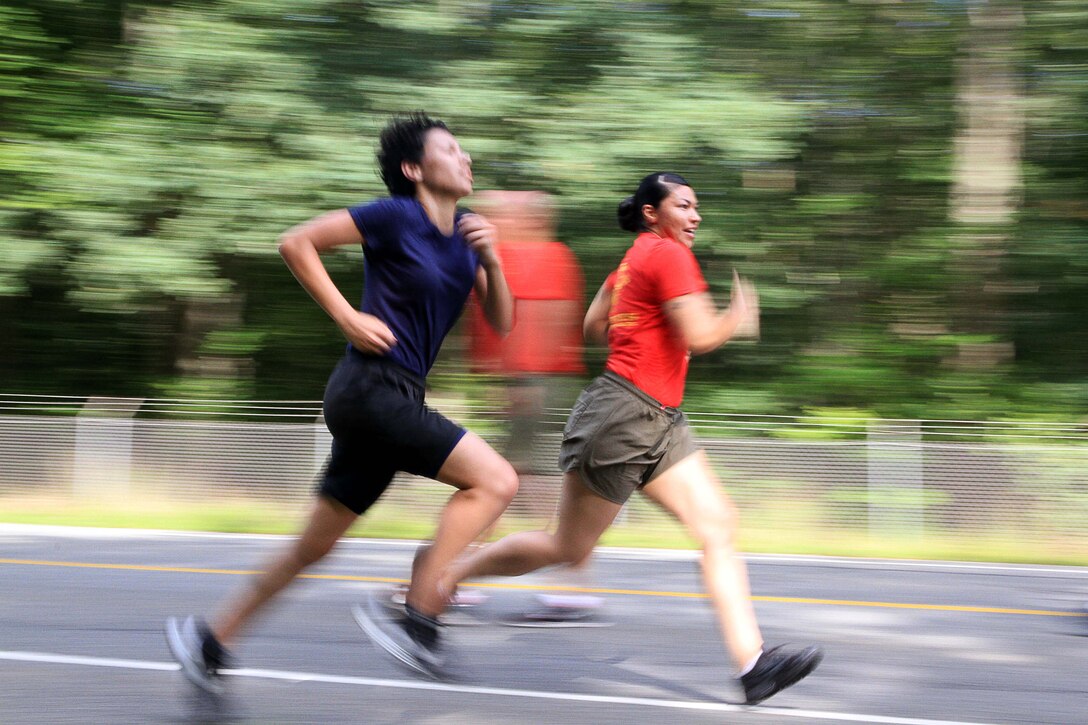 Sgt. Rosa Luna, a recruiter with Recruiting Substation Waterbury, motivates Gisel Gomez, a female Poolee, a woman currently enrolled in the Marine Corps’ Delayed Entry Program, during a run as part of an Initial Strength Test on Westover Air Reserve Base, Aug., 15. The Delayed Entry Program is meant to help prepare young men and women for the rigors of Marine Corps Boot Camp. Gomez, 20, is from Worcester, Massachusetts, and a graduate of Worcester Vocational Technical High School. (Official Marine Corps Photo by Staff Sgt. Richard Blumenstein)