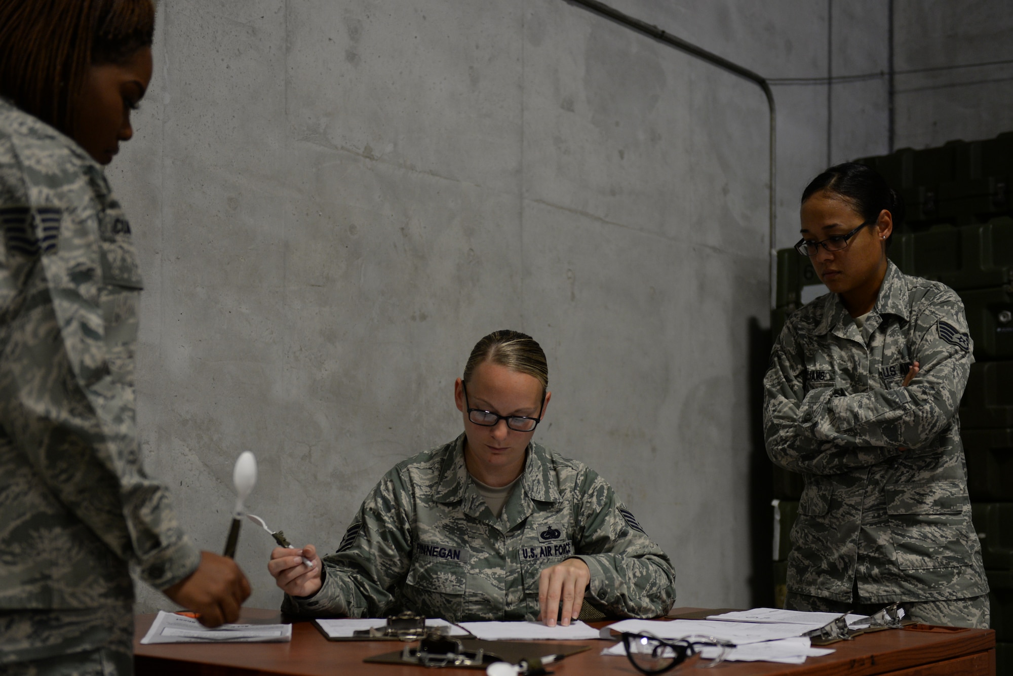 U.S. Air Force Staff Sgt. Nicole Finnegan, 18th Logistics Readiness Squadron central storage supervisor, inspects and reviews mock deployment orders on Kadena Air Base, Japan, Aug. 13, 2015. The 18th LRS Material Management flight trains on Thursdays to ensure the right Airman is outfitted with the right individual protection equipment for each exercise, contingency or operation. (U.S. Air Force photo by Senior Airman Omari Bernard)
