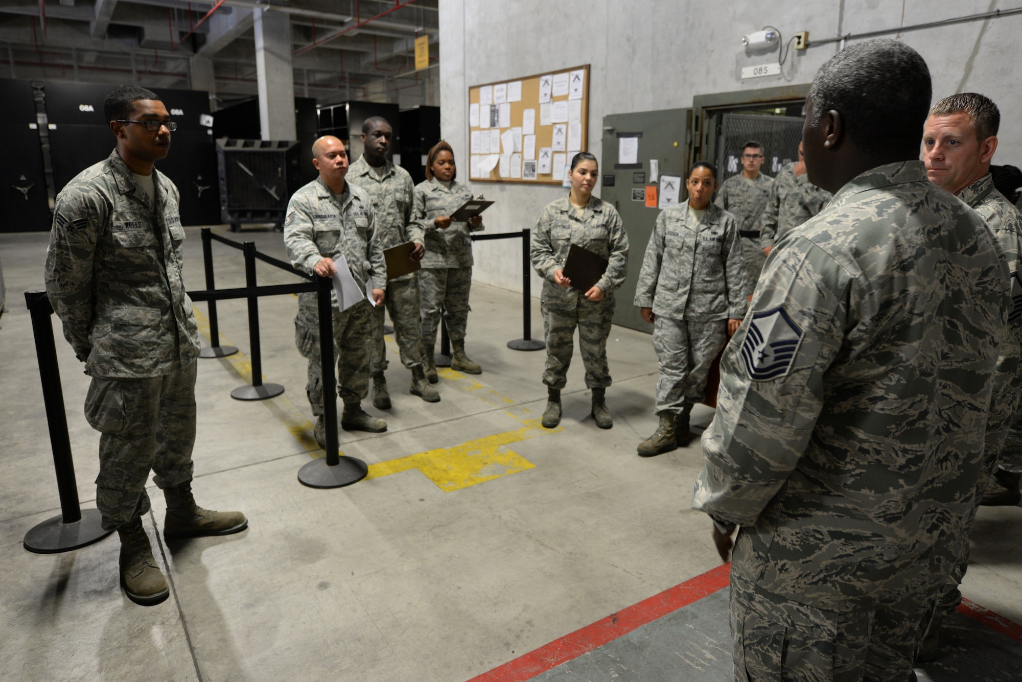 U.S. Air Force Master Sgt. Joey Johnson, 18th Logistics Readiness Squadron NCO in charge of individual protection equipment, reviews the processes of issuing IPE with his team on Kadena Air Base, Japan, Aug. 13, 2015. The 18th LRS Material Management flight maintains more than 52,000 line items in their warehouse. (U.S. Air Force photo by Senior Airman Omari Bernard)