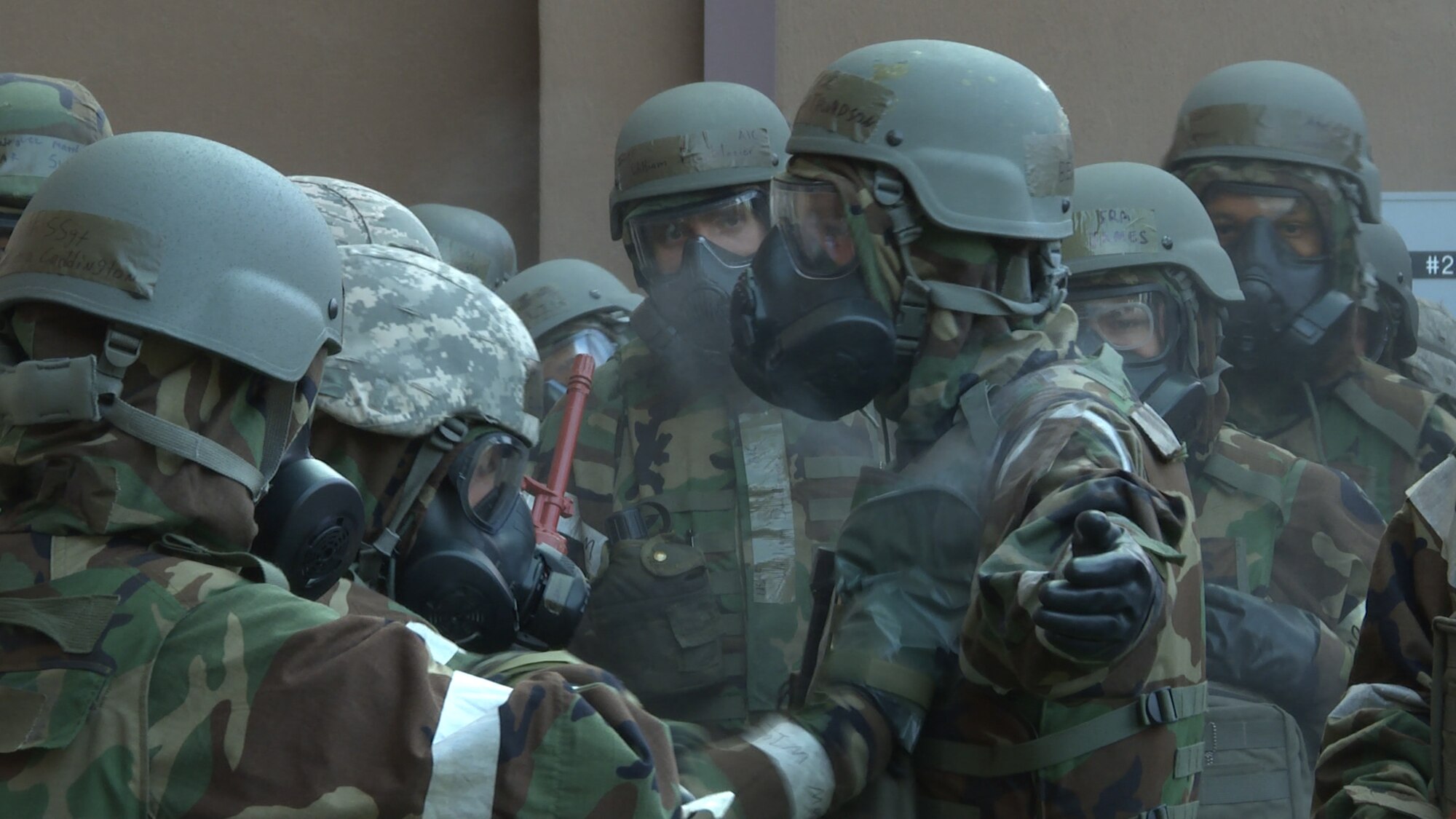 Senior Airman Ryan Clemmons, 51st Logistics Readiness Squadron fuels service center controller, pats down Airman 1st Class Benjamin Thompson, 51st Civil Engineer Squadron emergency management apprentice, with an M-295 decontamination kit during a simulated chemical attack Aug. 18, 2015, at Osan Air Base, Republic of Korea. Participants spent around 10 minutes going through all the steps to decontaminate themselves and their buddies. (U.S. Air Force photo by Staff Sgt. Benjamin Sutton)
