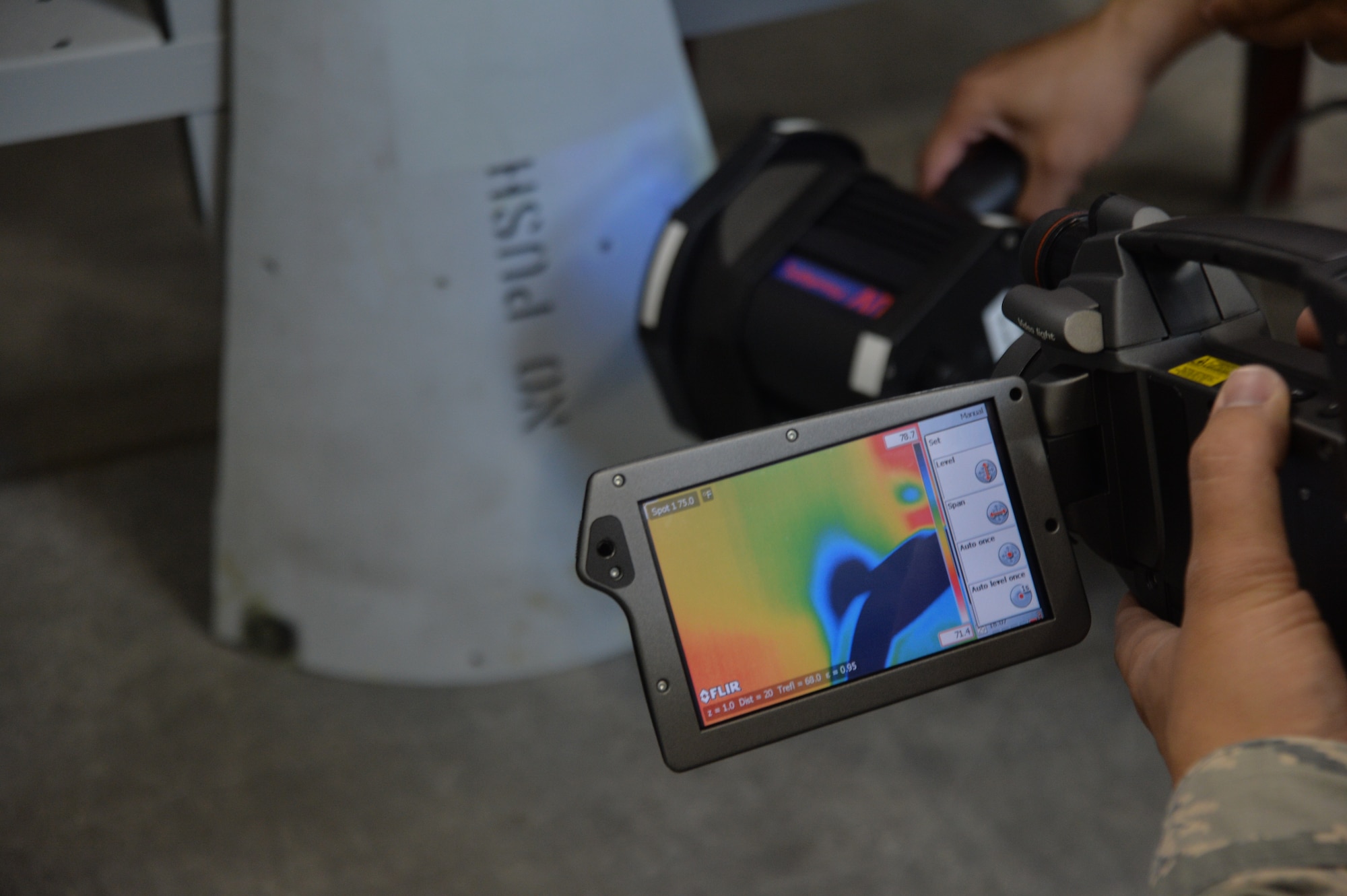 Airmen from the 432nd Maintenance Squadron use a thermal imaging camera to inspect an aircraft part at Creech Air Force Base, July 29, 2015. The heating process of this aircraft part allows technicians to find discrepancies much faster. (U.S. Air Force photo by Senior Airman Adarius Petty)